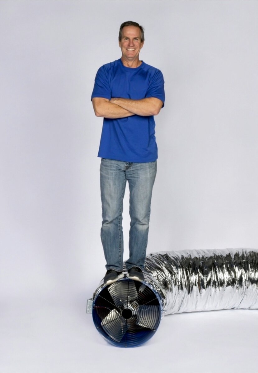 David Goodbrand — founder of Comfort Cool, standing on a Centric Air whole-house fan with insulated ductwork.